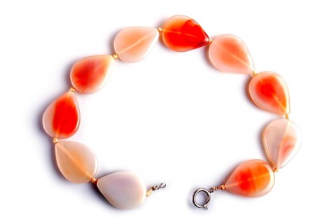 Agate colored beads isolated on white background. top view, close up