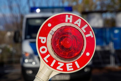 Police check: close-up of a police trowel with the inscription HALT POLIZEI in front of a police
