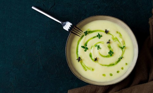 Mashed potatoes, with green butter, micro greenery, homemade, on a dark background, no people, top