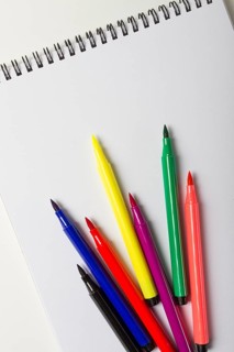 Watercolor pens brush, assortment, on a drawing album, artist's desk, top view, close-up, selective