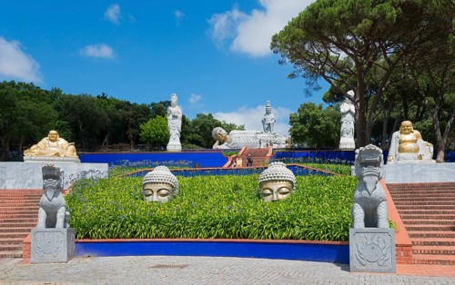 Spiritual garden with several Buddha statues and plants, radiating peace and tranquillity under a