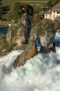 Rhine Falls seen from Laufen Castle, rocky island, Swiss flag, spray, Canton Zurich, on Neuhausen,