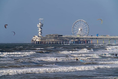 View over the beach of Scheveningen, the pier with Ferris wheel belongs to the city of The Hague