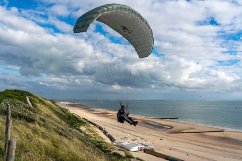 Paragliders along the dunes of Zoutelande, in Zeeland, South Holland, Netherlands