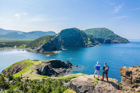 Aerial view, drone photo: Two men standing on a cliff above Bottle Cove, Bottle Cove Provincial