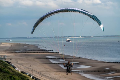 Paragliders along the dunes of Zoutelande, in Zeeland, South Holland, Netherlands