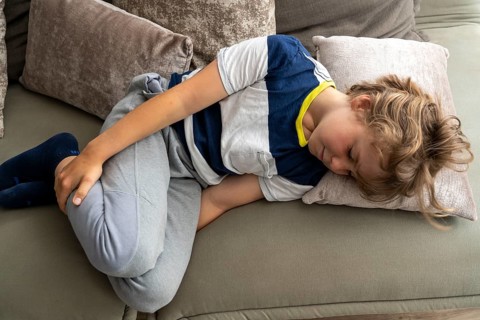 Growing pains in children, boy, 10 years old, has pain in his leg, symbolic picture
