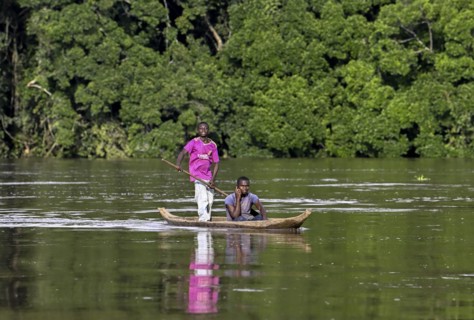 Two young men in a dugout canoe on the Sangha River, Dzanga-Sangha Complex of Protected Areas