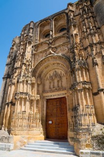 Impressive Gothic church façade with ornately carved portal and massive stone doors, Basilica Santa