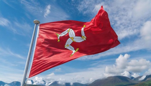 The flag of the Isle of Man, Great Britain, flutters in the wind