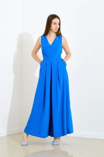 Full length portrait of stylish trendy woman in blue long sleeveless dress holding her hands in