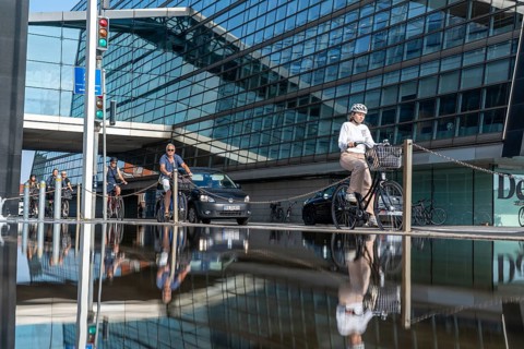 Cyclists on the cycle path on Christians Brygge Street, at the Black Diamond, Danish Royal Library,