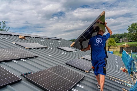 Installation of solar modules on the roof of a barn on a farm, over 240 photovoltaic modules are