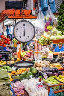 Scales and display of fruit and vegetables at a market stall, Mercado Central de San José, San