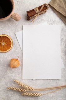 White paper invitation card, mockup with ear of wheat, bun, cup of coffee, linen textile, physalis