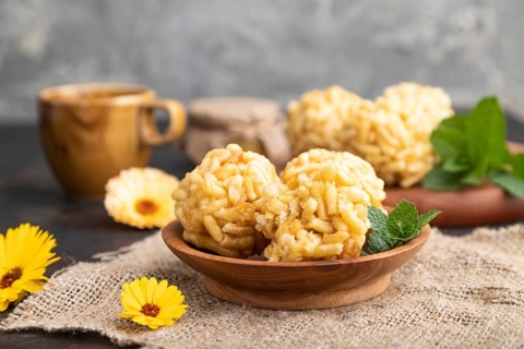 Traditional Tatar candy chak-chak made of dough and honey with cup of coffee on a black concrete