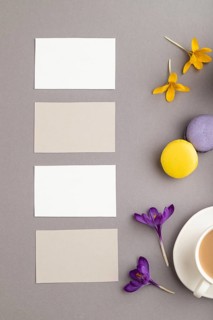 Gray and white business card mockup with spring snowdrop crocus flowers, cup of coffee,