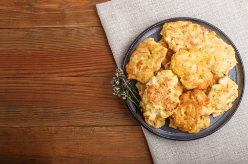 Minced chicken cutlets on brown wooden background. top view, flat lay, copy space