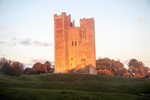 Late afternoon winter sunshine shining on walls of Orford Castle, Orford, Suffolk, England, United