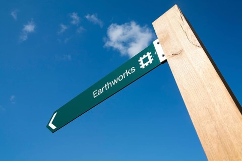 English Heritage signpost arrow for the Neolithic Hatfield earthworks site at Marden, Wiltshire,