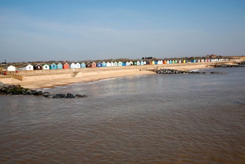 Colourful beach huts line the promenade at Southwold, Suffolk, England, United Kingdom, Europe