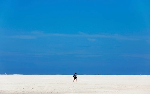 DEU, 18.06.2020, A holidaymaker walks through the knee sand on the beach of the island of Amrum,