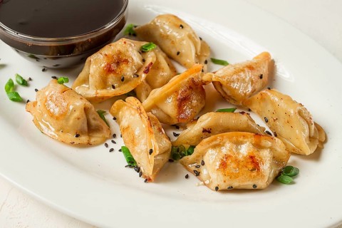 Japanese fried gyoza dumplings, with pork, sesame seeds, green onions
