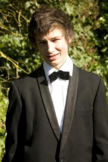 Model released portrait of young man wearing bow tie and suit jacket dressed for his school prom,