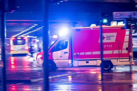 Ambulance on alarm, DRK, Essen fire brigade, rainy weather, city centre, evening, Essen, North