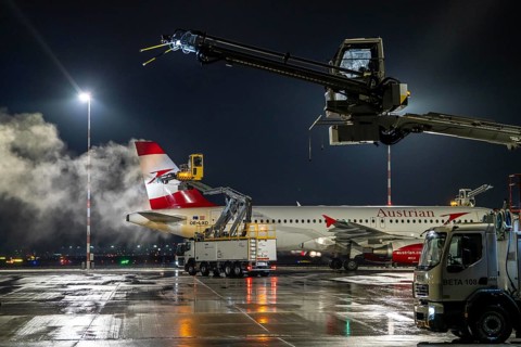 Winter at Frankfurt Main Airport, FRA, Austrian aircraft being de-iced by de-icing vehicles, Hesse,