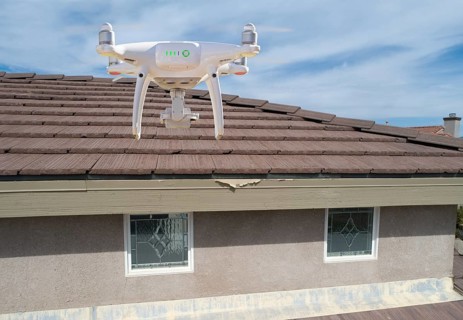 Quadcopter UAV drone flying A residential roof inspection