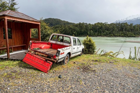 Wrack of a pickup at river Rio Baker upstream of village Caleta Tortel, road Carretera Austral,