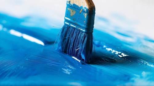 Thick paintbrush dipped in blue bristles dripping onto a white background, AI generated