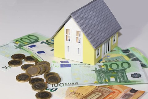 Concept photo with model house, euro notes and coins