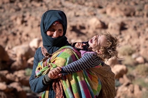 Berber woman, with baby on her back, traditional clothing, Morocco, Africa