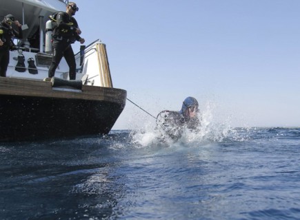 Diver jumping into the water from a dive boat, Red Sea, Egypt, Africa