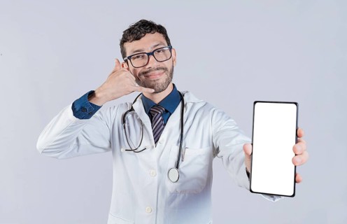 Handsome doctor showing cellphone screen gesturing call me. Happy doctor showing white screen of