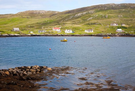 Croft houses along the shoreline at Leidag, Castlebay, Barra, Outer Hebrides, Scotland, UK