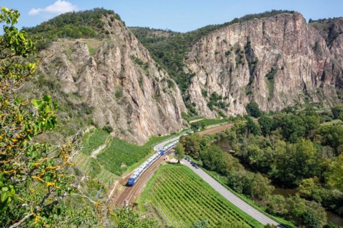 The Rotenfels with an Alstom Coradia LINT regional train operated by Vlexx in Traisen, Germany,