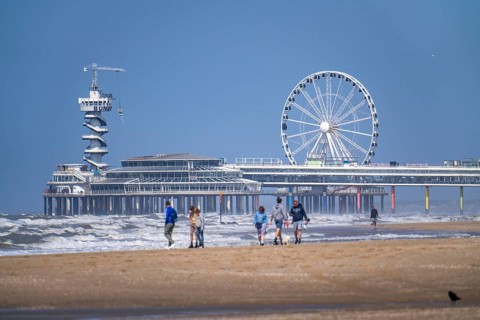 The pier and Ferris wheel at the Scheveningen beach, heavy swell, Netherlands