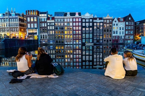 Canal houses on the Damrak, in the centre of the old town of Amsterdam, harbour, starting point of