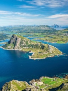 View from top of mountain Stornappstind to island Offersøya, large cliff in the sea, mountain