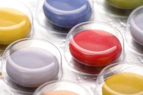 Colourful tablets packed in plastic, tablet addiction, drug addiction, studio