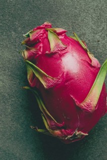 Dragon fruit, pitahaya, one piece, top view, rustic style, green background