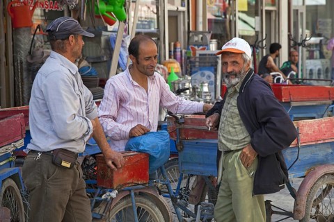 Turkish men chatting in a shopping street in the city Van, Eastern Turkey