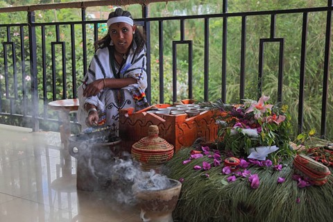 Attractive young woman, traditional coffee ceremony in a restaurant, roasting coffee beans and
