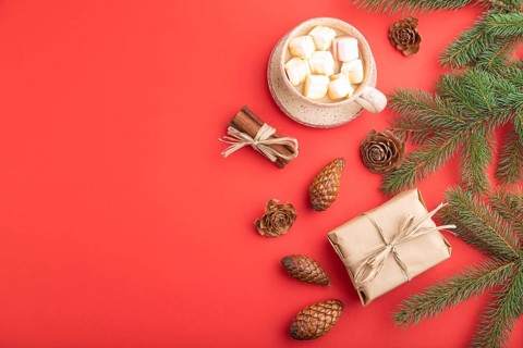 Christmas or New Year composition. Decorations, box, cinnamon, cones, fir and spruce branches, cup