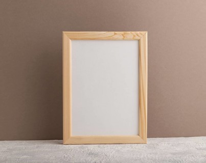 White wooden frame mockup on beige paper background. Blank, vertical orientation, still life, copy