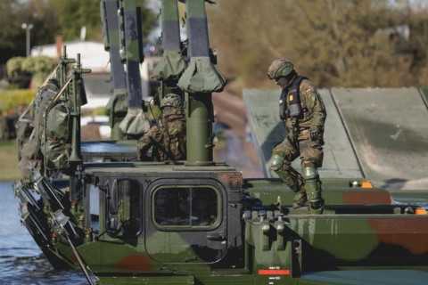 An engineer soldier stands on an amphibious vehicle of the type Amphibie M3 of the Bundeswehr,