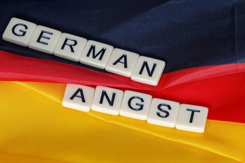 Symbolic image of German Angst: letter cube on a German flag